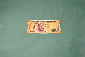 Modern Indian Two Hundred Rupees Currency Note on a minimal green background