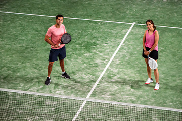 mixed padel match in a padel court indoor