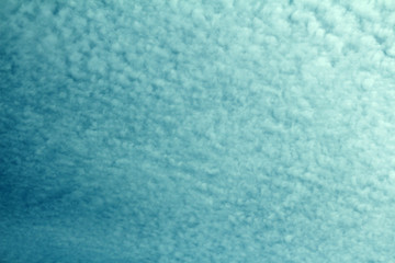 Fototapeta na wymiar continuous fluffy soft cirrus clouds on a blue sky. abstract natural background for design and text