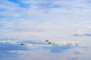 Fototapeta na wymiar Three airplanes high in the blue clear sky.