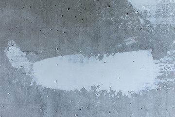 Puttying the wall with white putty, concrete wall with smeared irregularities, apartment repair