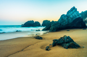 Rocky Atlantic ocean coastline of Adraga beach, Portugal