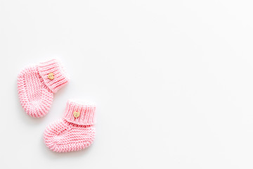 Cute baby booties for girl on white background top view copyspace