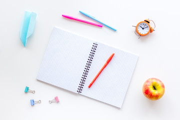 Creative mess on student's desk on white background top view