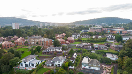 Fototapeta premium Aerial view on estate and mansions. View of Houses from above against sunset sky and mountains in Belfast Northern Ireland 