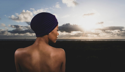Portrait of beautiful African American woman at sunset wearing turban