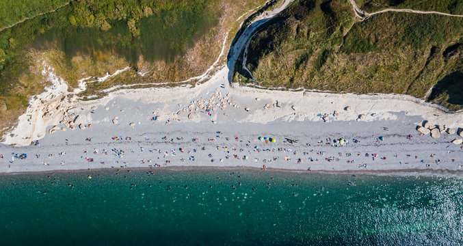 Drone view of the Tilleul beach with people chilling out and Antifer valley on background in Etretat Normandy France