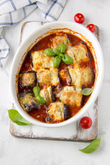 Baked eggplant rolls with meat (minced pork, beef, veal, lamb) in tomato sauce with herbs. Delicious summer food, traditional