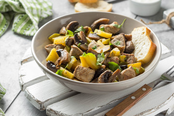 Roast meat (pork, beef) with potatoes, zucchini and mushrooms. Autumn fried stew with sour cream and parsley, traditional food, hearty tasty lunch