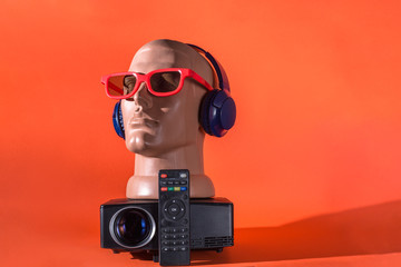 Everything for a home theater: projector, headphones, 3D glasses (on a mannequin head)