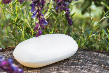 Lavender with soap on a wooden background. Soap for the face.