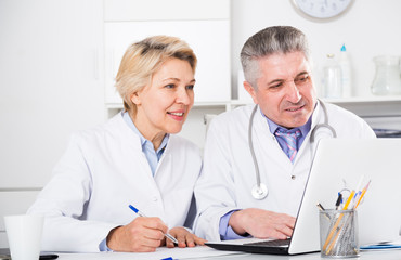 Doctor and nurse reading information