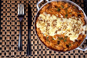 Sausage Risotto, Italian risotto served with Italian sausage and onion pepper mix ,tossing in spicy tomato sauce topped with parmesan cheese