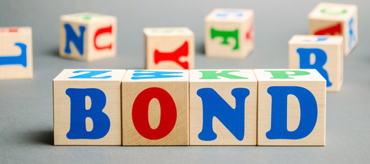 Wooden blocks with the word Bonds. A bond is a security that indicates that the investor has provided a loan to the issuer. Equivalent loan. Unsecured and secured bonds