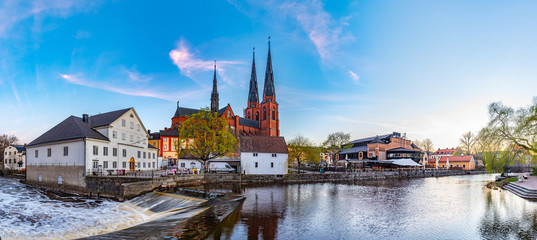 Sunset view of white building of Uppland museum and cathedral in Uppsala, Sweden - obrazy, fototapety, plakaty