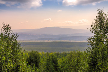 View of Ural mountains at evening in haze 