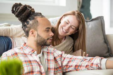 Attractive young couple together at home