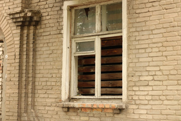 smashed a shot of an old brick building planked window at the Donbass in Ukraine