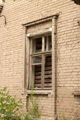 Fototapeta na wymiar smashed a shot of an old brick building planked window at the Donbass in Ukraine