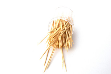Fototapeta premium Toothpicks isolated on white background. Tooth picks spilling out of container.