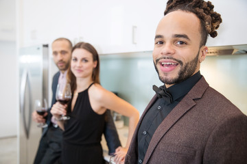Group of friends together at cocktail party in home