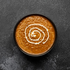 Dal Makhani at dark background. Dal Makhani - traditional indian cuisine puree dish with urad beans, red beans, butter, spices and cream.