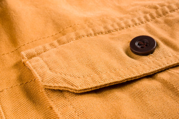 clothing items stonewashed cotton fabric texture with seams, clasps, buttons and rivets, macro