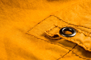 clothing items stonewashed cotton fabric texture with seams, clasps, buttons and rivets, macro