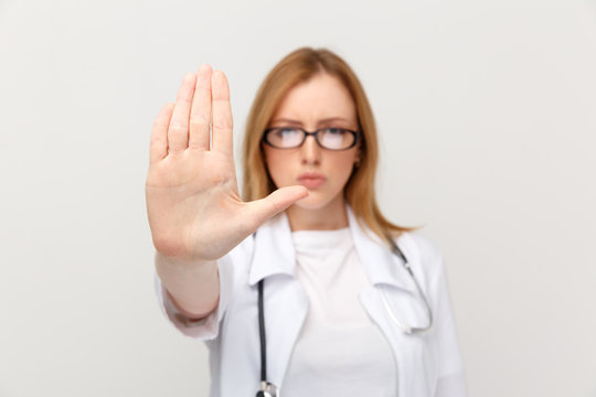 Sserious Woman Doctor In Glasses Showing Stop Sign Isolated In The White Studio