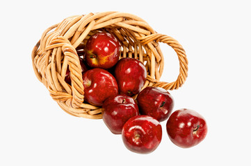Small Basket With Red Apples Spilling Out Isolated
