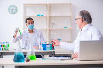 Two chemists working in the lab