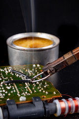Soldering of an integrated circuit in an electronics workshop. Small electronic works.