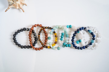 High angle view on crystal semiprecious stone beads bracelets gems natural stones for manifesting...