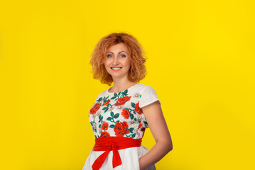 happy woman with arms folded standing looking at camera smiling