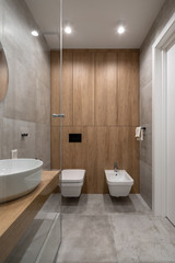 Fototapeta na wymiar Stylish modern bathroom with light tiled walls and floor