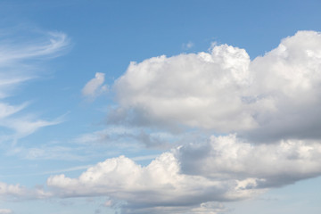 Blue sky and clouds. Cumulus clouds on a blue sky. Cloudy summer, spring or winter weather. Background with free space and empty place.