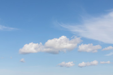 Blue sky with white clouds. In the sky you can see fluffy clouds and feather clouds. Background with free space and empty place.
