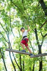 young boy, teenager, in a rope park, engage in extreme games, child development, boy hobbies