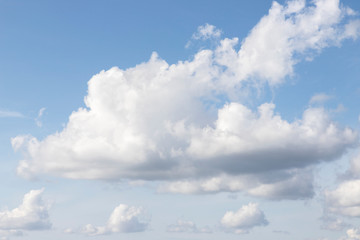 Blue sky and white clouds. White fluffy clouds in the daytime sky. Sunny weather. Background with free space and empty place.