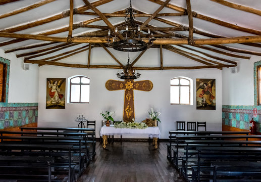 Sacred Valley, Peru - 05/21/2019: Colorful Spanish church and market place in Yucay, Peru.