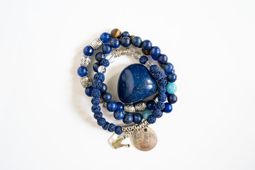 High angle view on crystal semiprecious stone beads bracelets gems natural stones for manifesting...