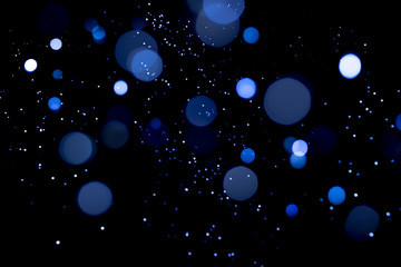 Blue abstract bokeh on dark background. Holiday concept