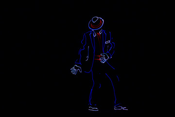 Dancers in suits with LED lamps.