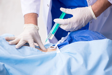 Female patient getting an injection in the clinic