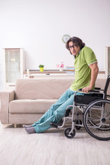 Fototapeta na wymiar Young male student in wheelchair at home
