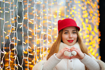Adorable woman showing heart sign