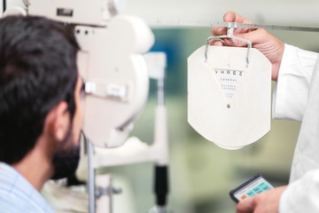  Patient in modern ophthalmology clinic checking the eye vision .