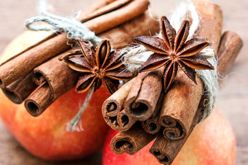 Red apple with cinnamon sticks spices decorated anise with star. Festive Merry Christmas composition. New year card. Holiday theme. Banner Background