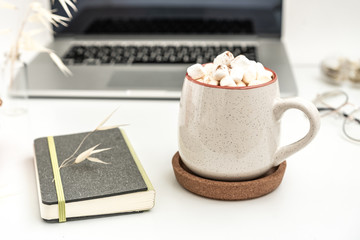 Autumn workspace still life. Notebook and daily planner mock-up scene with stationary, glasses and hot warming drink pumpkin latte ore coffe  with marshmallows. Fall feminine styled composition