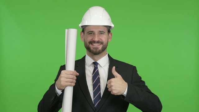 Happy Engineer with Blueprint showing Thumbs Up against Chroma Key